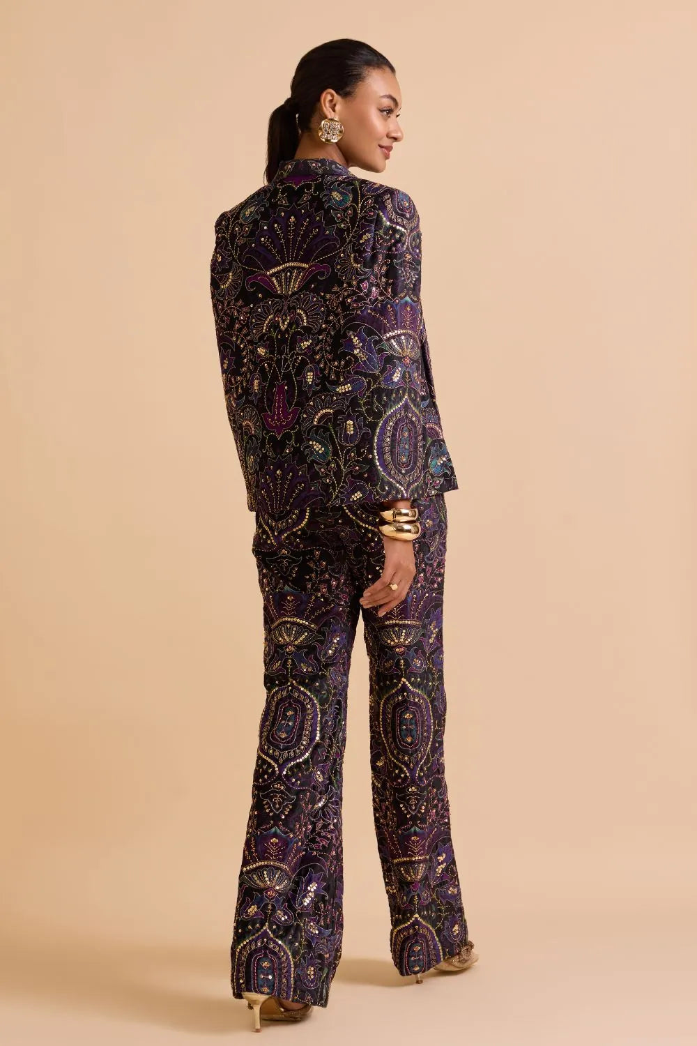 Back View of Aarohi Jacket with Pants in purple velvet featuring intricate thread and sequin detailing, perfect for women's party wear, festive celebrations and evening occasions.