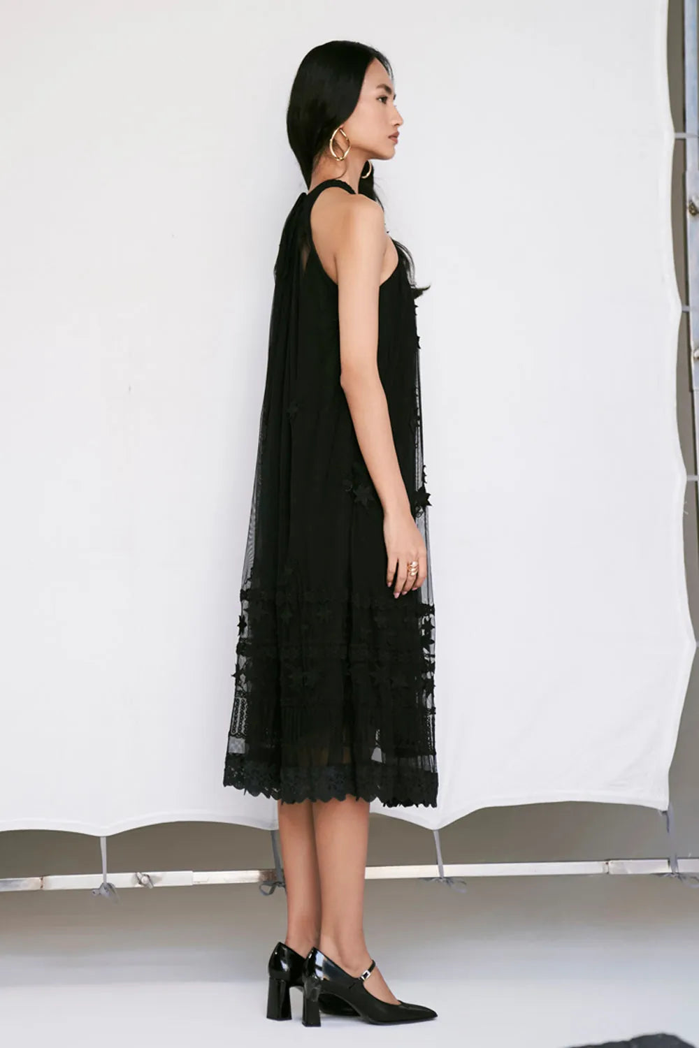 Edda Dress women's black tulle dress featuring a contemporary silhouette and elegant sheer-textured fabric, designed for a sophisticated statement look, styled for festive evenings, cocktail gatherings, vacation outings and special occasions.