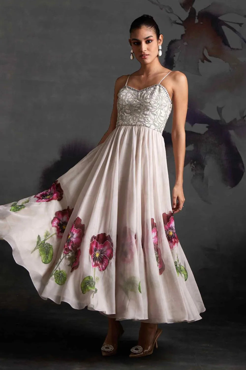 Ivina Corset Dress women's ivory organza maxi dress featuring a structured corset bodice, delicate sequin embellishments over a floral print and a flowing floor-length silhouette, styled for resort celebrations, summer weddings, formal gatherings and special occasions.