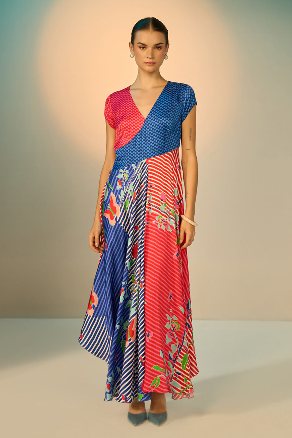Jora Dress women's multicolour dress featuring vibrant red and blue colour blocking, artistic striped and floral-inspired prints and a flowing silhouette, styled for destination weddings, sunset soirées, luxury resort holidays and statement evening occasions.