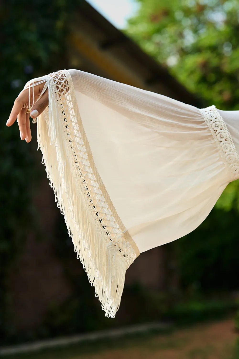 Kriti Sanon wearing the Femi Cape With Shorts, a women's ivory chiffon co-ord set featuring a flowing cape with delicate lace detailing and matching shorts with lace accents, styled for beach holidays, resort vacations, poolside gatherings and elegant summer getaways.