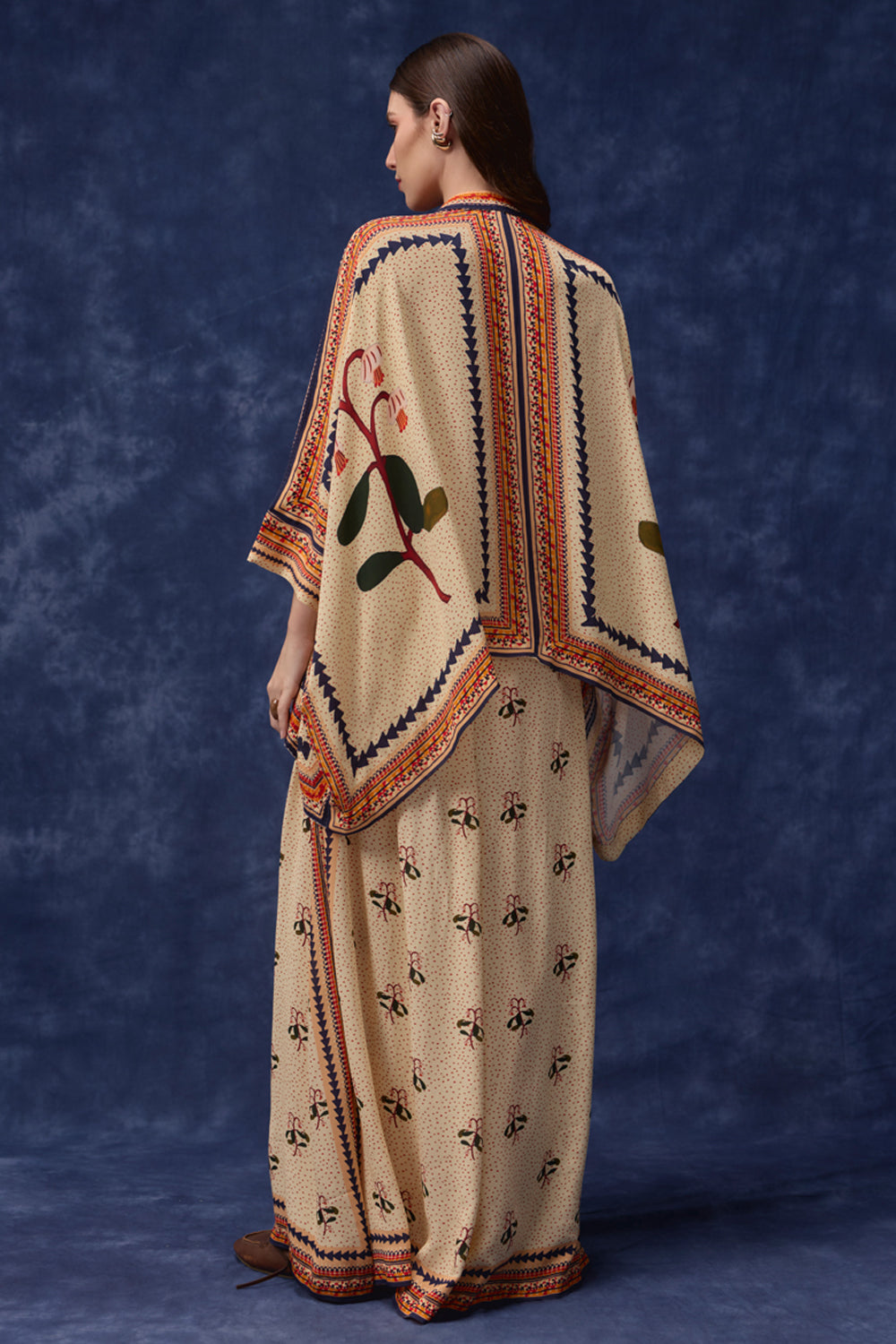 back view of Lana Embroidered Cape With Pants women's co-ord set featuring a flowing embroidered cape paired with matching pants, combining intricate detailing with an elegant relaxed silhouette, styled for festive gatherings, resort dinners, destination celebrations and special occasions.