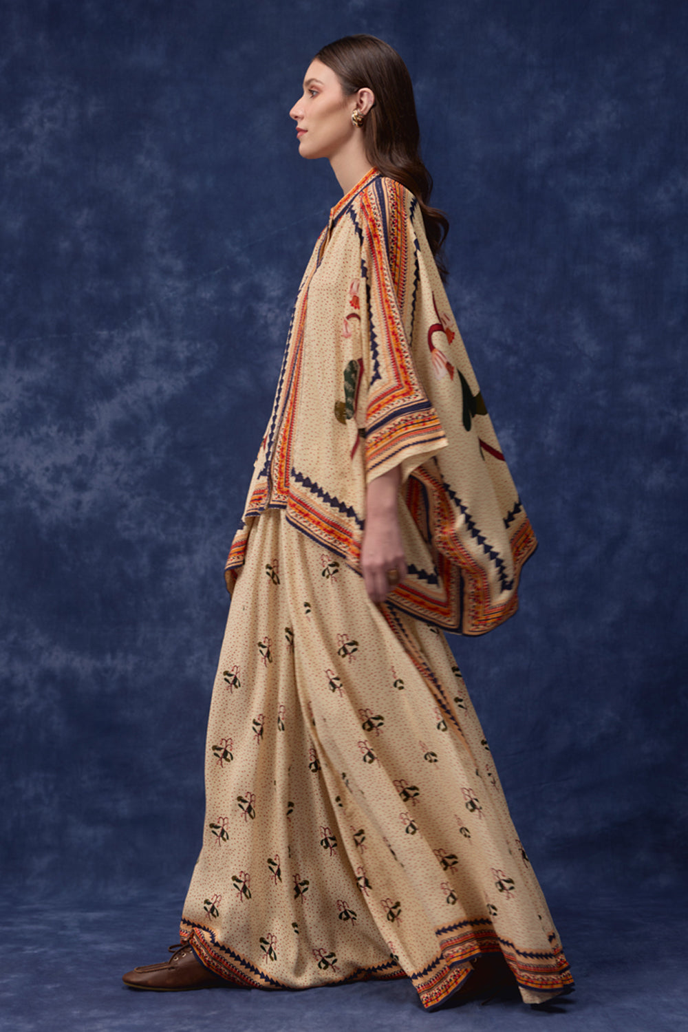 Side view of Lana Embroidered Cape With Pants women's co-ord set featuring a flowing embroidered cape paired with matching pants, combining intricate detailing with an elegant relaxed silhouette, styled for festive gatherings, resort dinners, destination celebrations and special occasions.