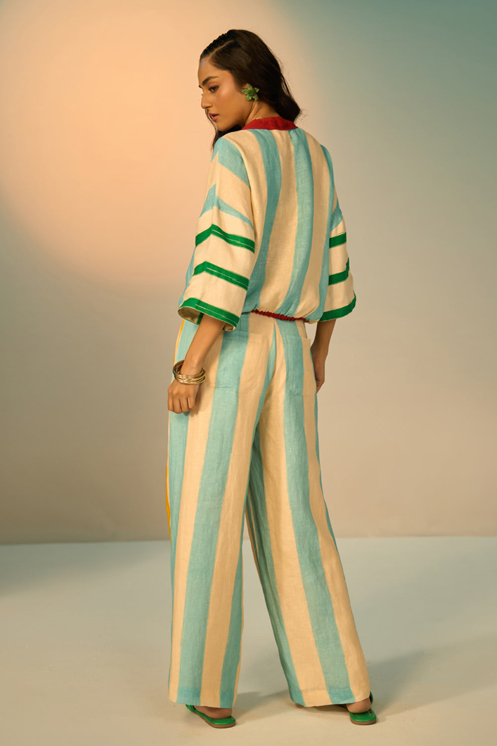 Leni Pants women's multicolour pants featuring a vibrant striped pattern and relaxed, flowing silhouette, designed for comfortable statement dressing, styled for resort vacations, summer outings, brunches and casual everyday wear.