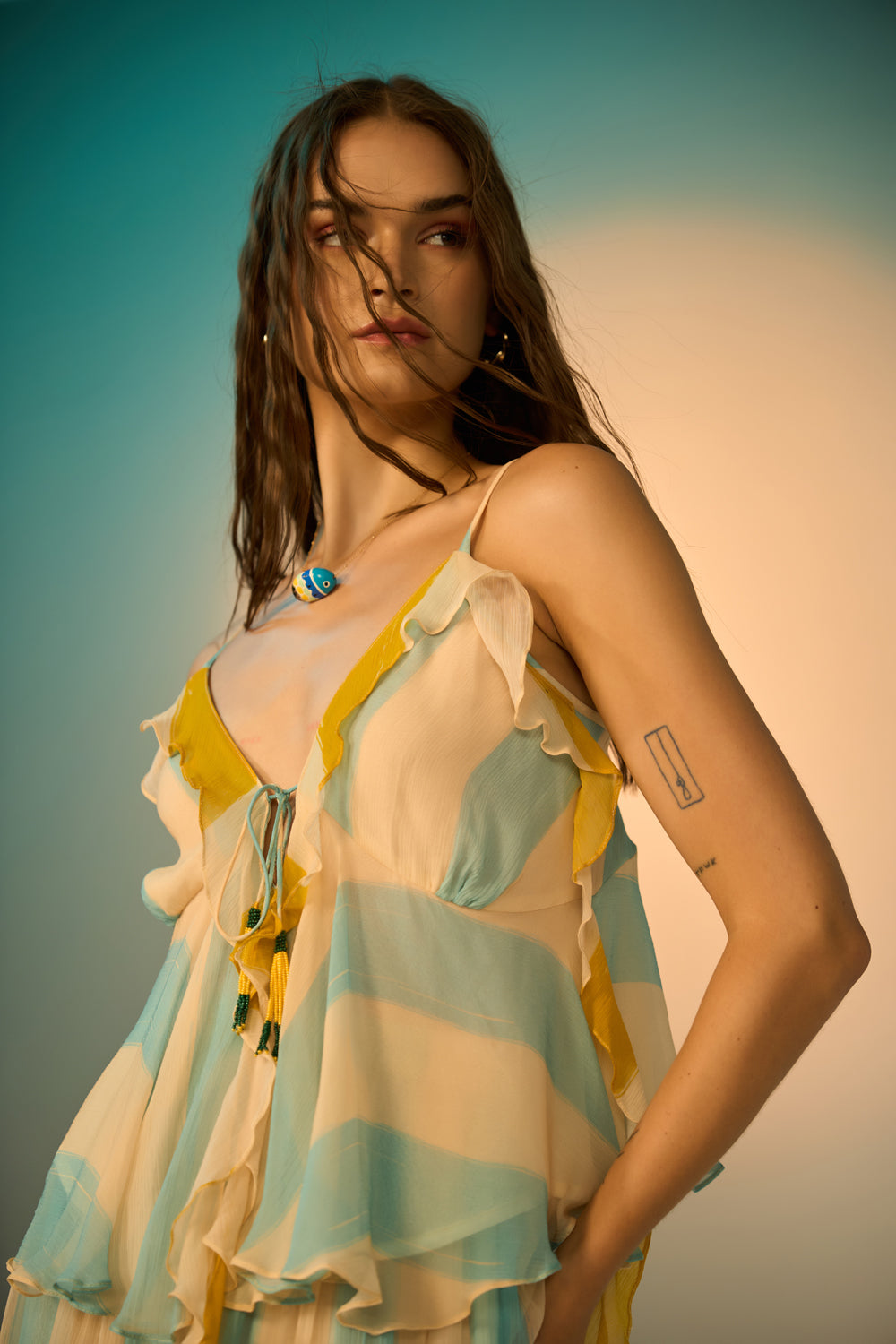Petro Spaghetti Blouse women's multicolour viscose chiffon blouse featuring delicate adjustable spaghetti straps, a plunging neckline framed with ruffles, a smocked back, a cinched waist and a circular frill hem with beaded tassel accents, styled for resort holidays, beach days, sunset outings and casual evenings.
