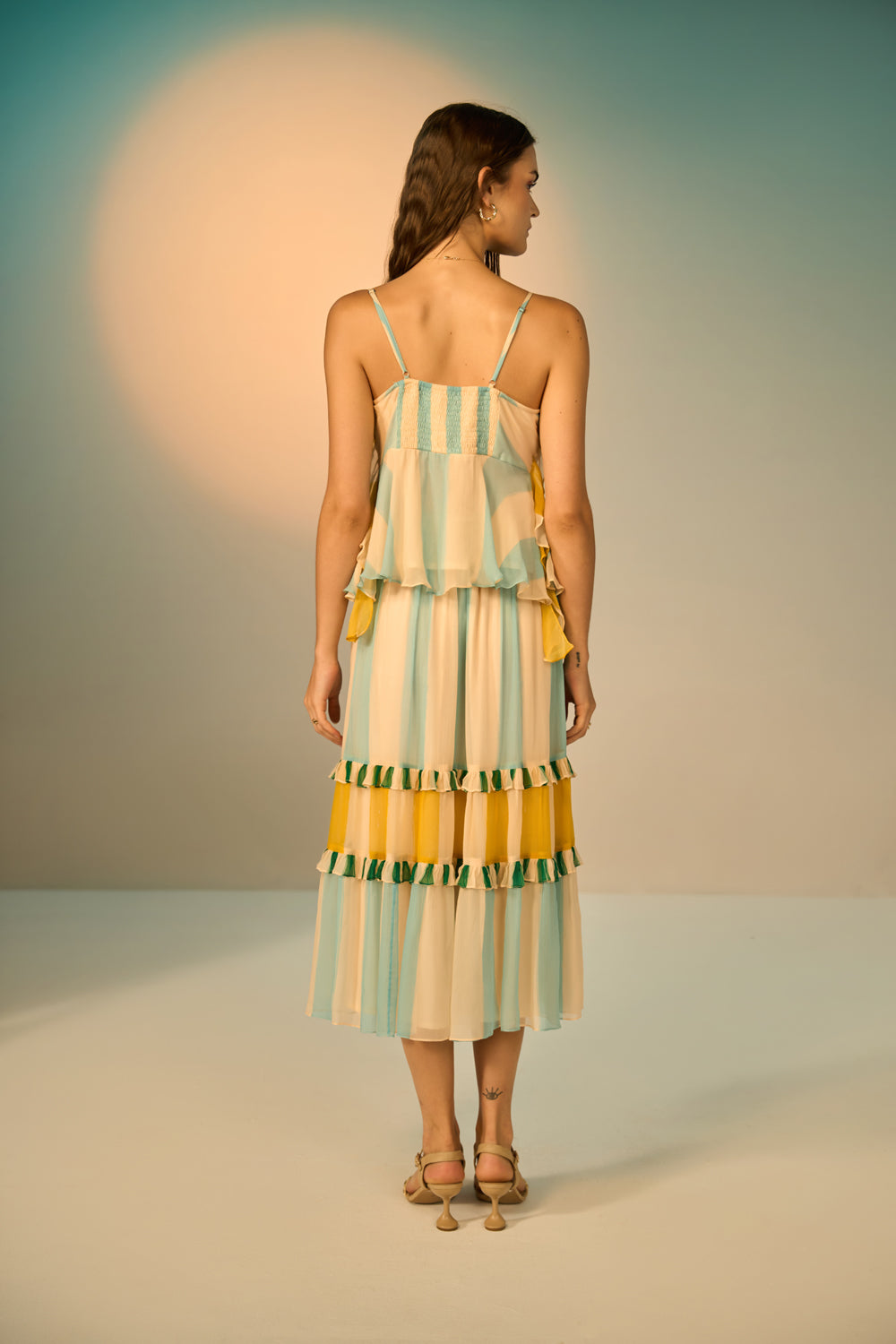 Back view of Petro Spaghetti Blouse women's multicolour viscose chiffon blouse featuring delicate adjustable spaghetti straps, a plunging neckline framed with ruffles, a smocked back, a cinched waist and a circular frill hem with beaded tassel accents, styled for resort holidays, beach days, sunset outings and casual evenings.