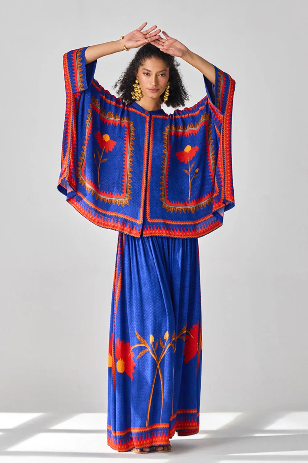 Romina Cape Pants women's co-ord set featuring a flowing cape-style top paired with matching pants, combining an elegant silhouette with contemporary styling, suited for resort vacations, summer celebrations, festive gatherings and special occasions.