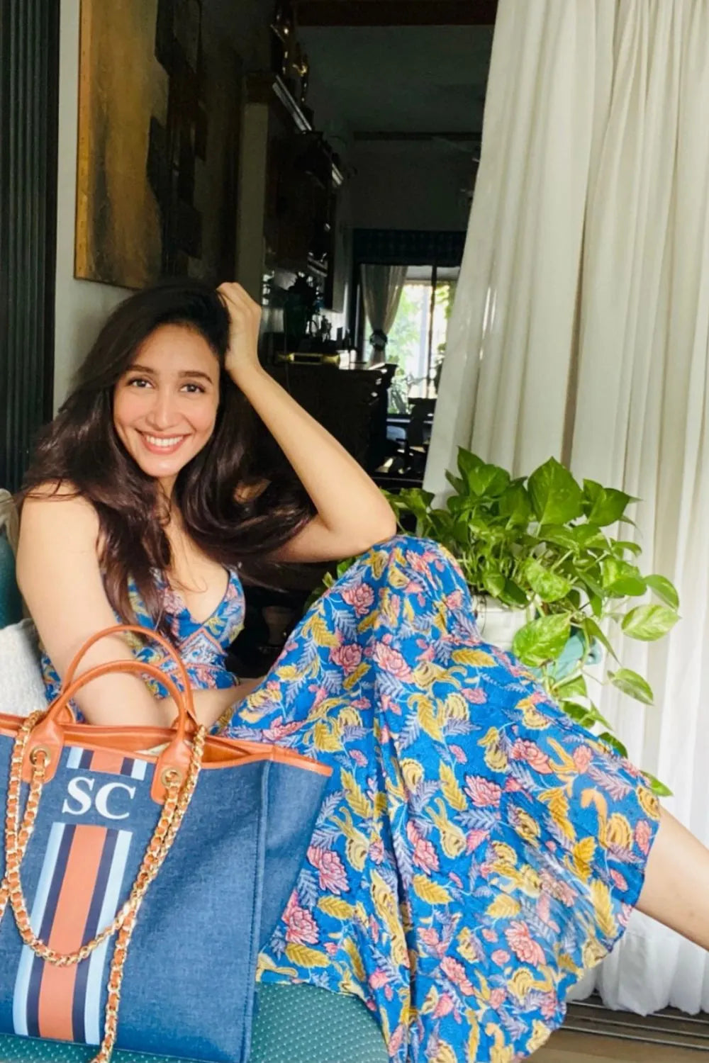 Shreya Chaudhry wearing the Insia Spaghetti Dress, a women's cobalt blue viscose georgette maxi dress featuring a vibrant multicolour print, delicate spaghetti straps and a flowing 54-inch silhouette, styled for summer holidays, beach getaways, resort evenings and destination celebrations.