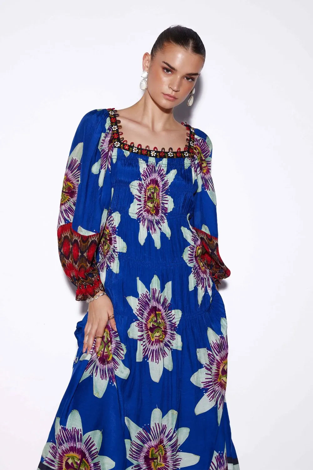 Closeup look of Tatiana Tier Maxi Dress, a women's maxi dress featuring a flowing tiered silhouette and statement printed design, styled for resort vacations, summer holidays, destination celebrations and elegant daytime occasions.