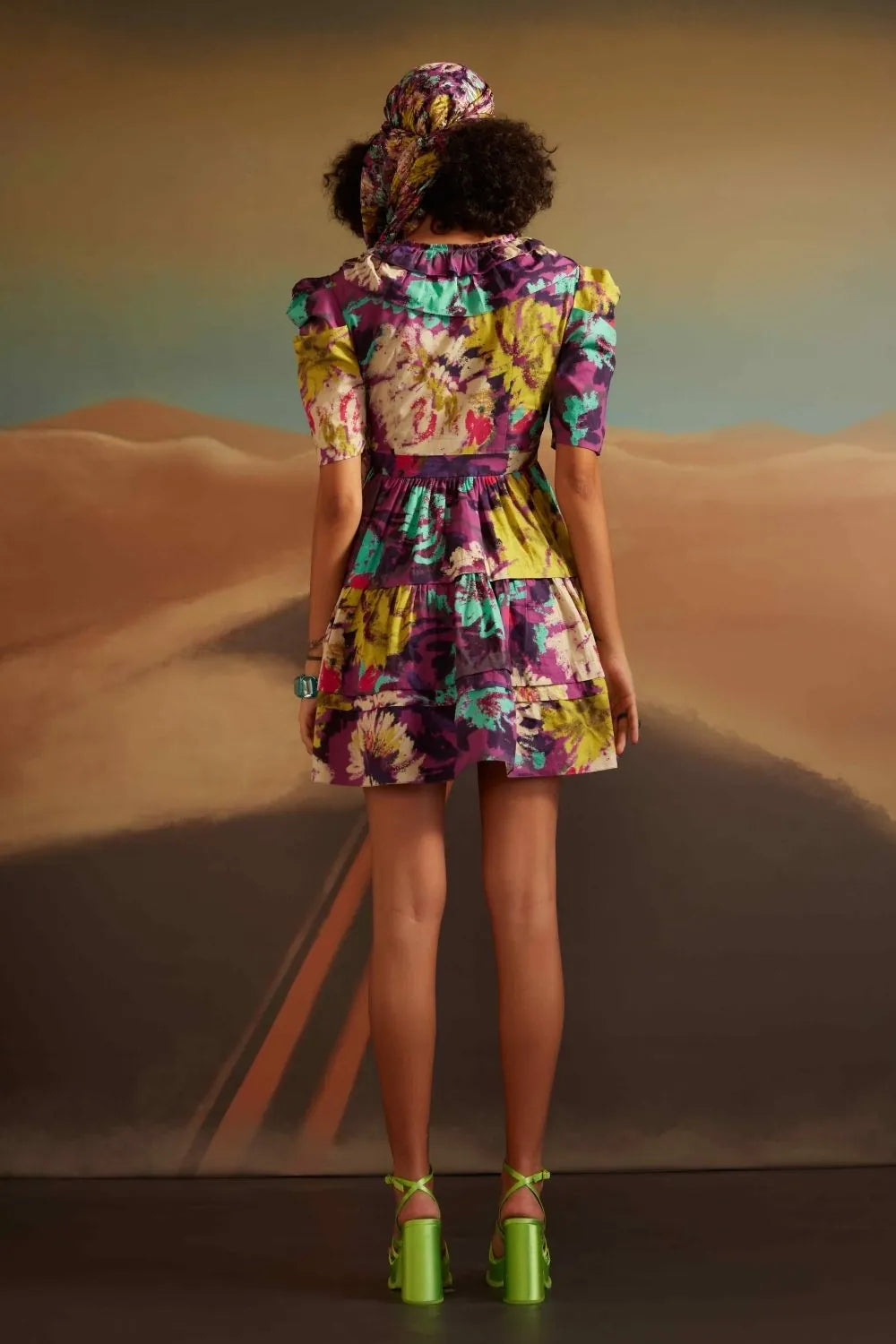 Back view of Ainara wrap dress with printed purple design perfect for brunches and workwear for woman