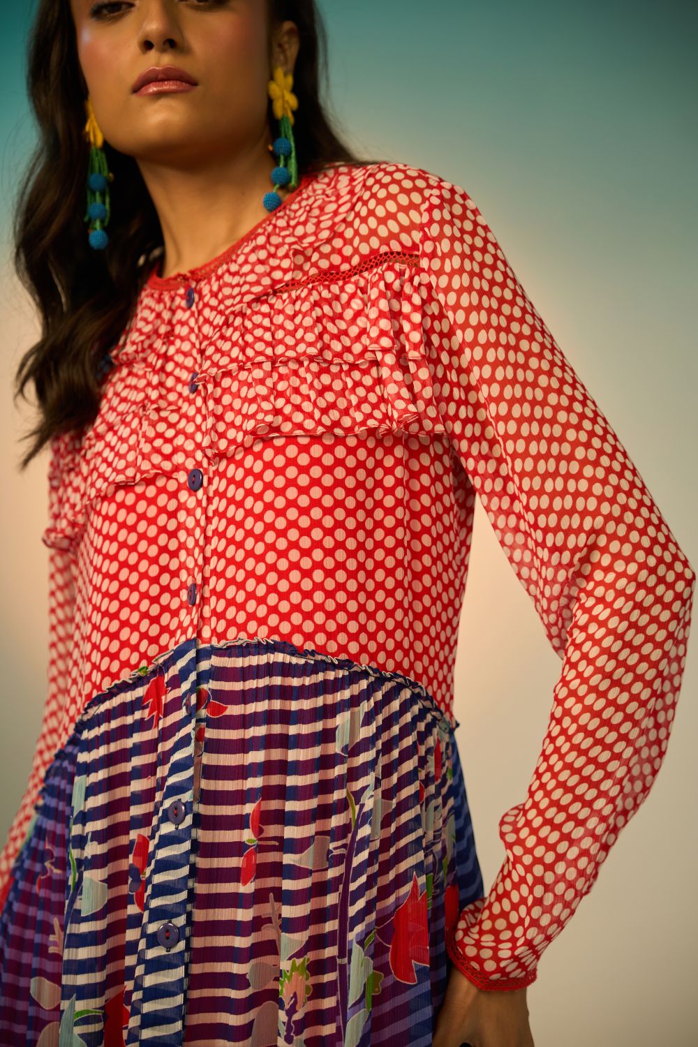 A close-up look of a woman wearing a red and blue striped dress with a clean background