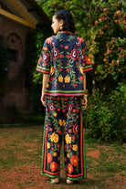 Back view of Amira shirt with pants set, a black breathable cotton embroidery with silhouette, perfect for festive styling and elevated day-to-night looks for woman.