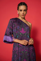 Woman wearing a purple floral dress against a red background