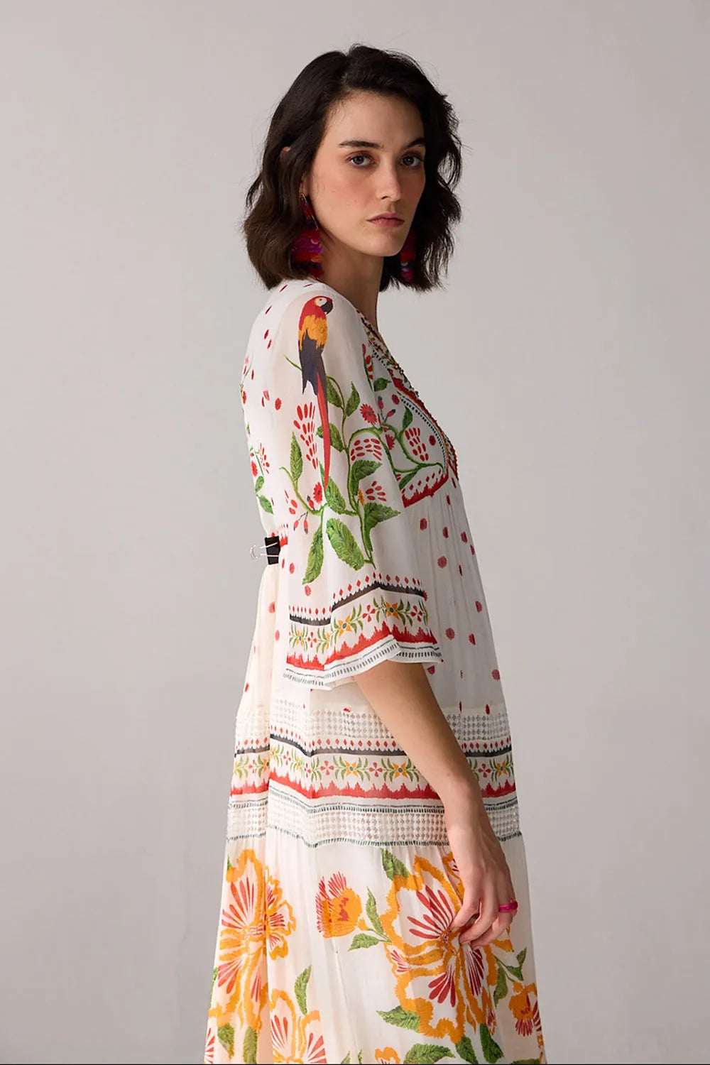 Side view of Delilah Embroidered Maxi Dress women's ivory viscose georgette maxi dress featuring a beautifully embroidered neckline with delicate thread and bead detailing, an elegant flowing silhouette and airy finish, styled for summer holidays, resort dinners, garden parties and special occasions.