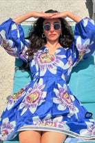 Delraaz Bunshah wearing the Amara Mini Dress, a women's cobalt blue cotton satin mini dress featuring an eye-catching printed design and relaxed swing silhouette, styled for summer outings, brunches, resort vacations and casual celebrations.