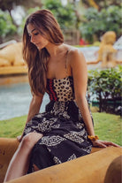 Devki Bhatt wearing the Martha Spaghetti Dress, a women's black viscose georgette maxi dress featuring a multipatch and stippling print, delicate spaghetti straps and distinctive cutout detailing, styled for resort vacations, summer evenings and destination celebrations.