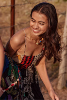 Devki Bhatt wearing the Martha Spaghetti Dress, a women's black viscose georgette maxi dress featuring a multipatch and stippling print, delicate spaghetti straps and distinctive cutout detailing, styled for resort vacations, summer evenings and destination celebrations.