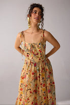 Dixie Dress women's beige chiffon maxi dress featuring a corset-fitted bodice, an elegant flowing skirt and an adjustable smocked back for a flattering fit, styled for summer getaways, resort dinners, luncheons and special occasions.