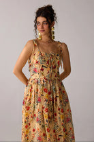 Dixie Dress women's beige chiffon maxi dress featuring a corset-fitted bodice, an elegant flowing skirt and an adjustable smocked back for a flattering fit, styled for summer getaways, resort dinners, luncheons and special occasions.