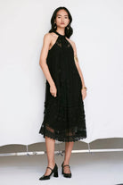 Edda Dress women's black tulle dress featuring a contemporary silhouette and elegant sheer-textured fabric, designed for a sophisticated statement look, styled for festive evenings, cocktail gatherings, vacation outings and special occasions.