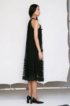 Edda Dress women's black tulle dress featuring a contemporary silhouette and elegant sheer-textured fabric, designed for a sophisticated statement look, styled for festive evenings, cocktail gatherings, vacation outings and special occasions.