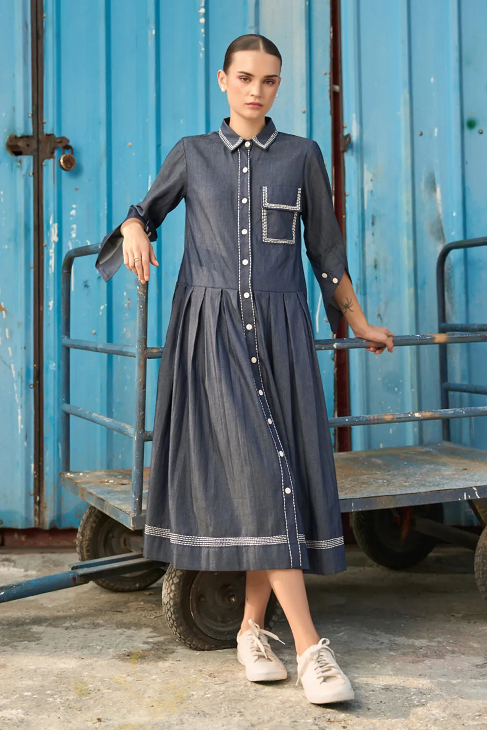 Elma Dress women's dark blue chambray midi dress featuring a structured shirt collar, button-down front, three-quarter sleeves with buttoned cuffs, a statement chest pocket with contrast stitching and a softly pleated skirt, styled for work meetings, casual outings and day-to-evening occasions.