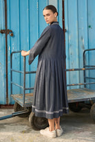 Back view of Elma Dress women's dark blue chambray midi dress featuring a structured shirt collar, button-down front, three-quarter sleeves with buttoned cuffs, a statement chest pocket with contrast stitching and a softly pleated skirt, styled for work meetings, casual outings and day-to-evening occasions.
