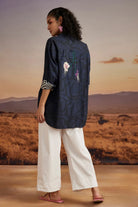 Back view of Elsie Shirt women's bluish-black cotton poplin shirt featuring a relaxed free-size silhouette, clean tailoring and a versatile contemporary design, styled for casual outings, smart-casual occasions, summer holidays and everyday wear.