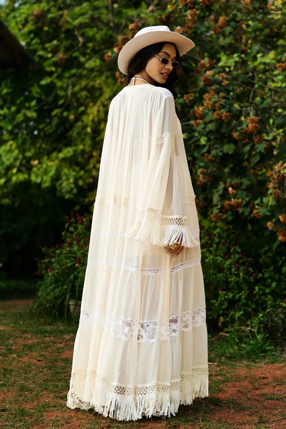 Back view of Femi Cape with Shorts women's ivory chiffon co-ord set featuring a flowing long cape with delicate all-over lace detailing and matching shorts with lace accents, styled for beach holidays, resort vacations, poolside gatherings and elegant summer getaways.