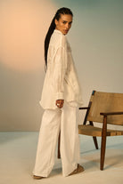 Back view of Florida Linen Shirt women's ivory linen shirt featuring delicate lace inserts across the collar, bodice and sleeves, wide billowing sleeves, a button-down front and a relaxed sheer silhouette, styled for beach holidays, summer brunches, resort vacations and effortless warm-weather dressing.