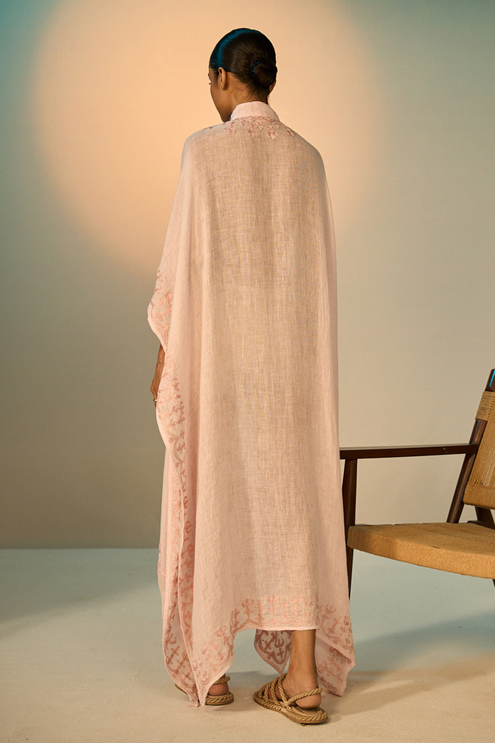 Back view of Ibiza Linen Coverup women's pink linen cover-up featuring intricate zari paisley embroidery along the neckline and sleeves, an open-front flowing silhouette and a separate detachable slip, designed for layering over swimwear during beach holidays, resort vacations and elegant summer getaways.
