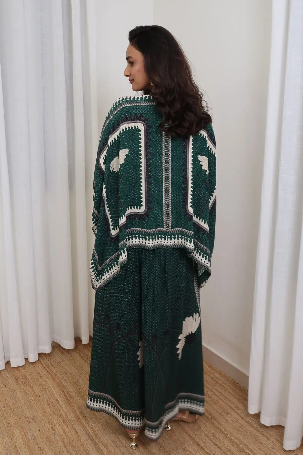 BAck view of Inessa Cape and Pants Set women's emerald green double georgette co-ord featuring a geometric printed cape blouse with a fluid, flowing silhouette and matching relaxed-fit pants, styled for resort holidays, summer brunches, destination celebrations and sophisticated day-to-evening occasions.