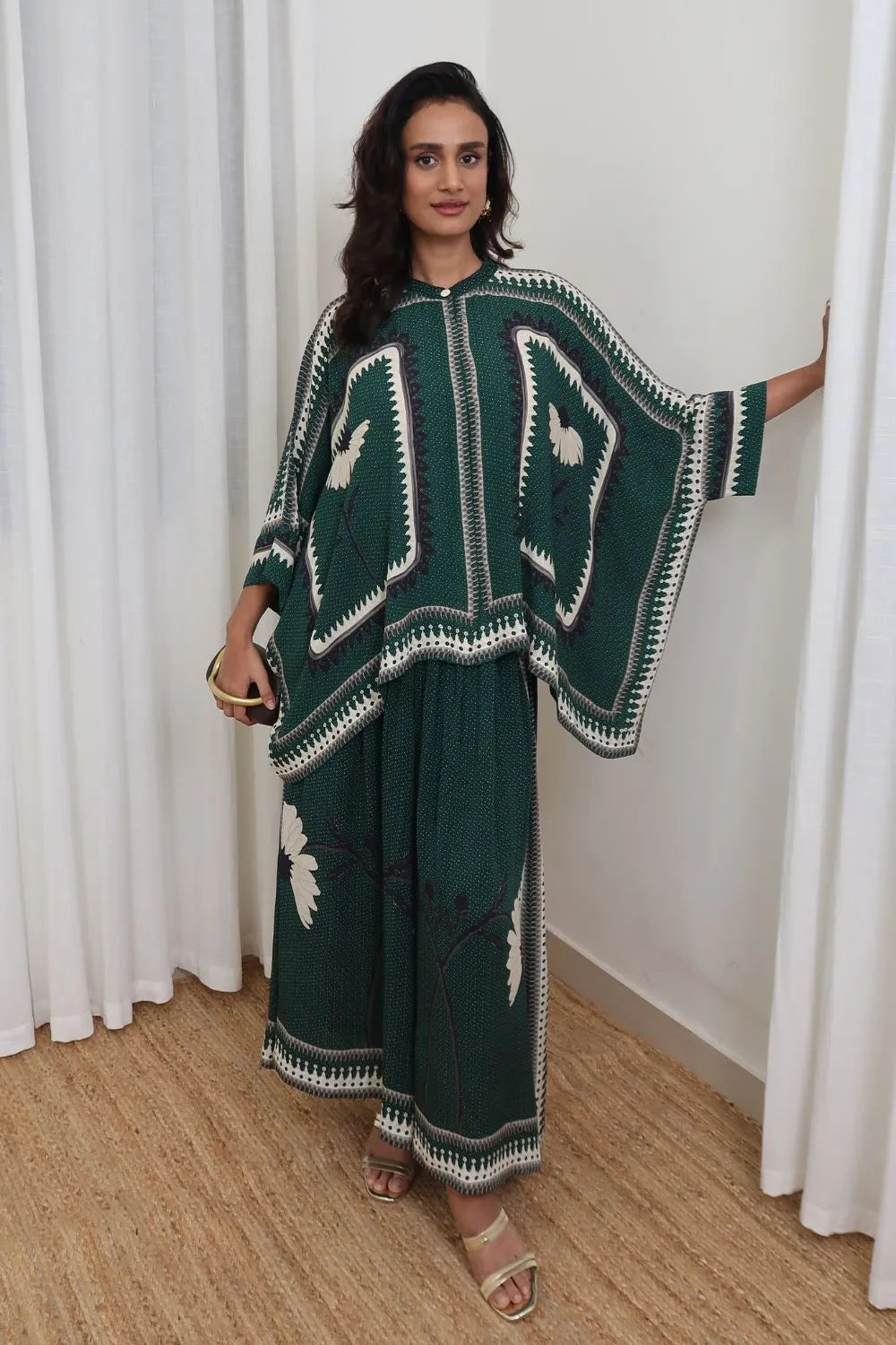 Inessa Cape and Pants Set women's emerald green double georgette co-ord featuring a geometric printed cape blouse with a fluid, flowing silhouette and matching relaxed-fit pants, styled for resort holidays, summer brunches, destination celebrations and sophisticated day-to-evening occasions.