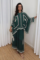 Inessa Cape and Pants Set women's emerald green double georgette co-ord featuring a geometric printed cape blouse with a fluid, flowing silhouette and matching relaxed-fit pants, styled for resort holidays, summer brunches, destination celebrations and sophisticated day-to-evening occasions.