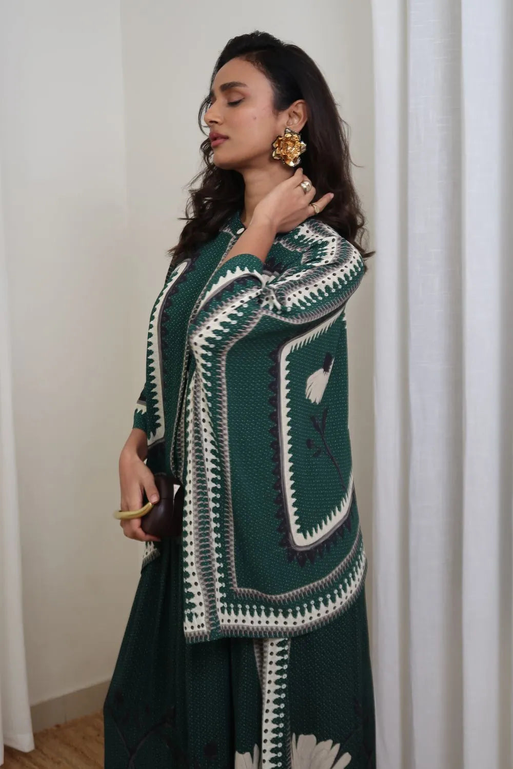 Side view of Inessa Cape and Pants Set women's emerald green double georgette co-ord featuring a geometric printed cape blouse with a fluid, flowing silhouette and matching relaxed-fit pants, styled for resort holidays, summer brunches, destination celebrations and sophisticated day-to-evening occasions.