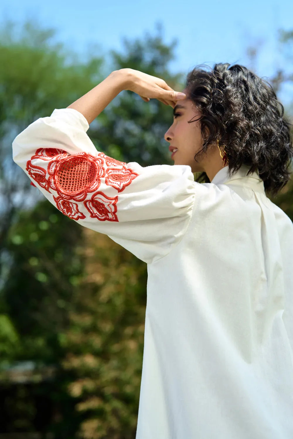 Ivar Embroidered Dress women's ivory cotton midi dress featuring intricate pearl cutwork embroidery on the sleeves, a relaxed silhouette and elegant handcrafted detailing, styled for summer brunches, daytime celebrations, garden gatherings and sophisticated casual occasions.