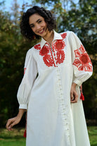 Closeup look of Ivar Embroidered Dress women's ivory cotton midi dress featuring intricate pearl cutwork embroidery on the sleeves, a relaxed silhouette and elegant handcrafted detailing, styled for summer brunches, daytime celebrations, garden gatherings and sophisticated casual occasions.