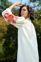 Closeup look of Ivar Embroidered Dress women's ivory cotton midi dress featuring intricate pearl cutwork embroidery on the sleeves, a relaxed silhouette and elegant handcrafted detailing, styled for summer brunches, daytime celebrations, garden gatherings and sophisticated casual occasions.
