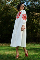 Full view of Ivar Embroidered Dress women's ivory cotton midi dress featuring intricate pearl cutwork embroidery on the sleeves, a relaxed silhouette and elegant handcrafted detailing, styled for summer brunches, daytime celebrations, garden gatherings and sophisticated casual occasions.