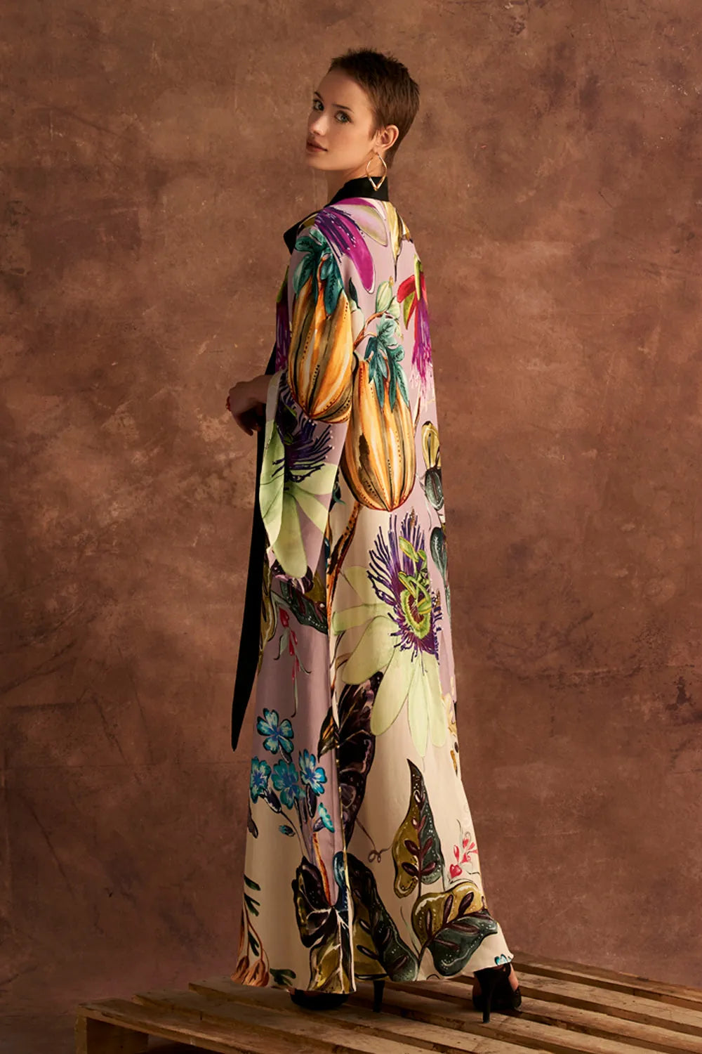 Back view of Jianna Dress women's multicolour double georgette maxi dress featuring a vibrant mixed print, dramatic flared sleeves and a flowing floor-length silhouette, styled for resort vacations, summer celebrations, destination dinners and elegant daytime occasions.