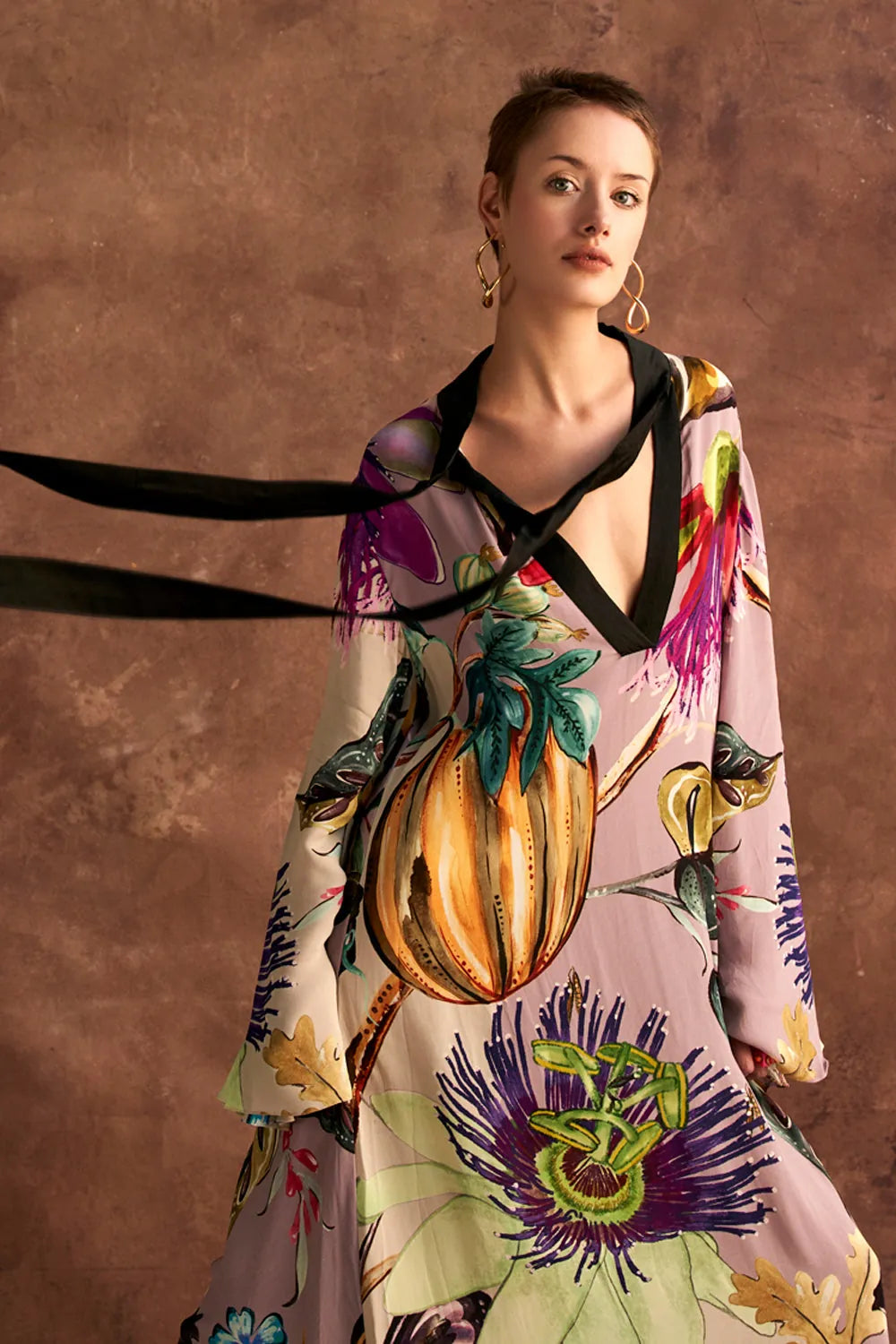 Jianna Dress women's multicolour double georgette maxi dress featuring a vibrant mixed print, dramatic flared sleeves and a flowing floor-length silhouette, styled for resort vacations, summer celebrations, destination dinners and elegant daytime occasions.