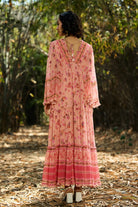 Back view of Joly Embroidered Maxi Dress women's peach and pink viscose georgette maxi dress featuring a playful printed design, V-neckline, beaded embroidered neckline and adjustable smocked waist, styled for weddings, summer holidays, resort dinners and special occasions.