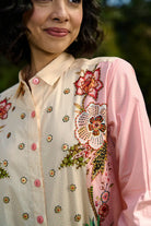 Closeup look of Keyla Shirt women's pink and cream cotton shirt featuring a bold colour-blocked floral print, vibrant contrasting hues and a relaxed longline silhouette, styled for summer holidays, resort outings, casual brunches and statement everyday dressing.