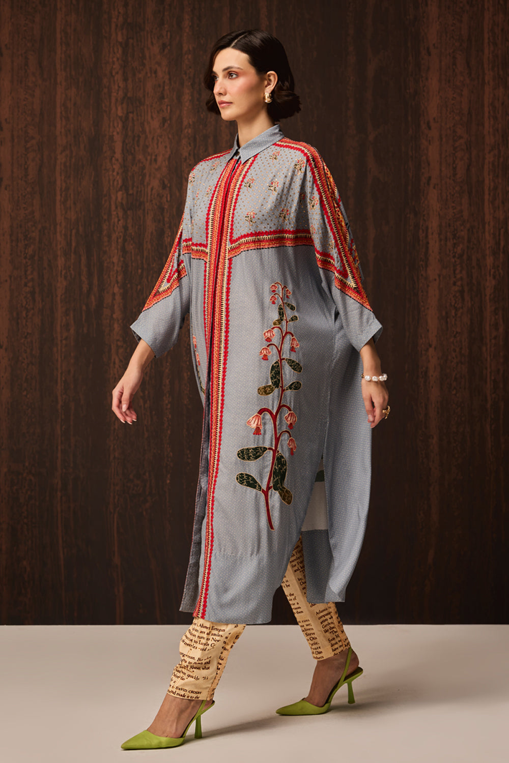 Kori Embroidered Shirt With Pants women's pale blue Double Georgette co-ord set featuring an oversized shirt with tonal embroidery and matching newspaper-print jogger pants, combining a relaxed silhouette with an artistic statement design, styled for airport looks, resort lounging, travel days and casual outings.