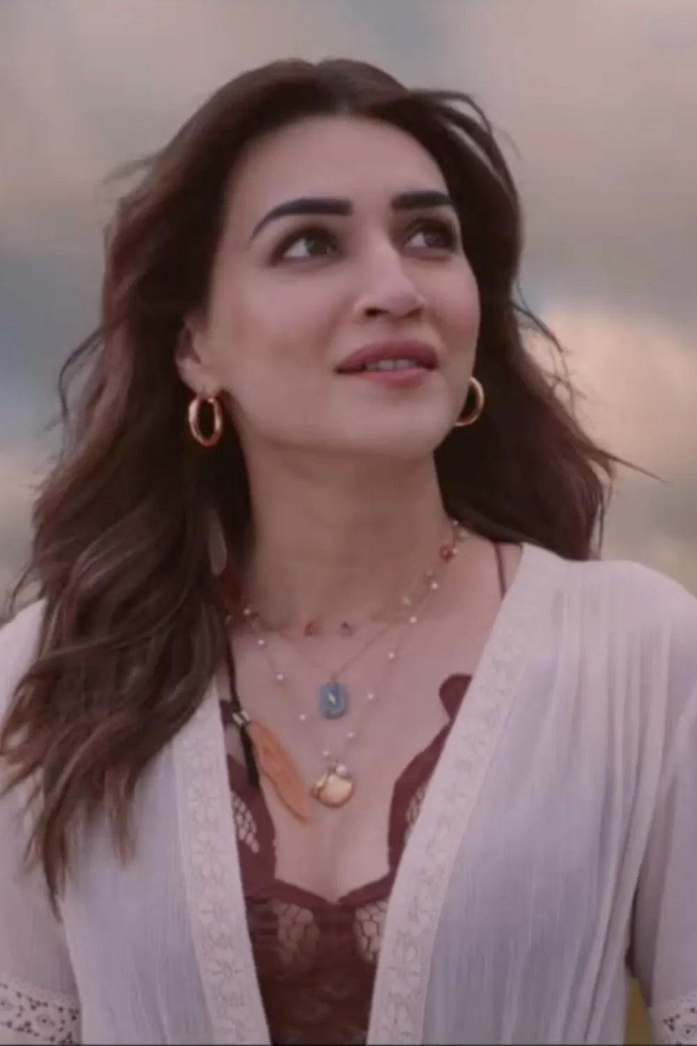 Kriti Sanon wearing the Femi Cape With Shorts, a women's ivory chiffon co-ord set featuring a flowing cape with delicate lace detailing and matching shorts with lace accents, styled for beach holidays, resort vacations, poolside gatherings and elegant summer getaways.