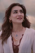 Kriti Sanon wearing the Femi Cape With Shorts, a women's ivory chiffon co-ord set featuring a flowing cape with delicate lace detailing and matching shorts with lace accents, styled for beach holidays, resort vacations, poolside gatherings and elegant summer getaways.