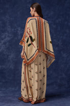 back view of Lana Embroidered Cape With Pants women's co-ord set featuring a flowing embroidered cape paired with matching pants, combining intricate detailing with an elegant relaxed silhouette, styled for festive gatherings, resort dinners, destination celebrations and special occasions.
