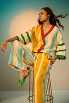 Leni Pants women's multicolour pants featuring a vibrant striped pattern and relaxed, flowing silhouette, designed for comfortable statement dressing, styled for resort vacations, summer outings, brunches and casual everyday wear.