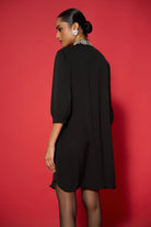 Back view of Lexi Embroidered Dress women's embroidered dress featuring intricate decorative detailing and a statement silhouette, styled for festive gatherings, evening celebrations, resort dinners and special occasions.