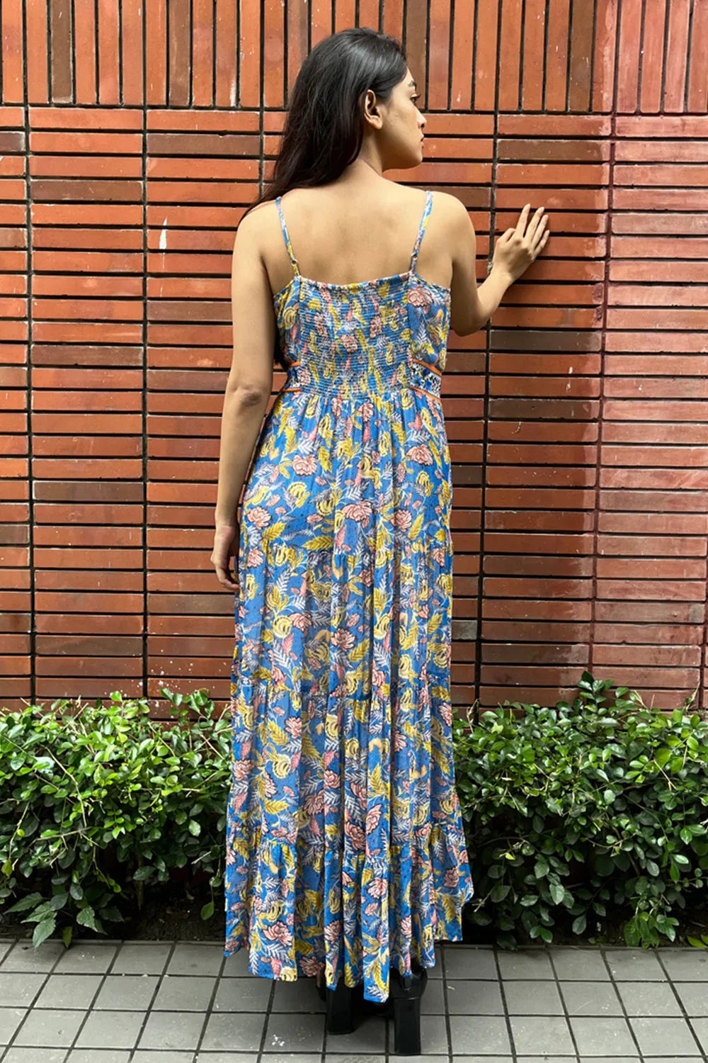 Back of Malini Agarwal wearing the Insia Spaghetti Dress, a women's cobalt blue viscose georgette maxi dress featuring a vibrant multicolour print, delicate spaghetti straps and a flowing 54-inch silhouette, styled for summer holidays, beach getaways, resort evenings and destination celebrations.